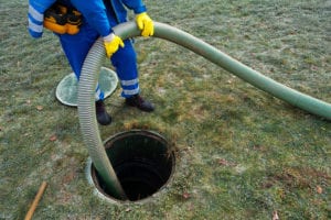 hose pumping out septic tank for septic tank cleaning in bloomington il