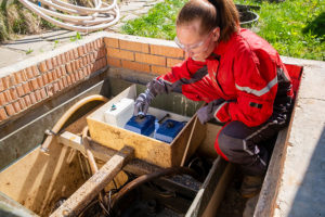 An experienced technician examines a residential septic system in Lincoln, IL.