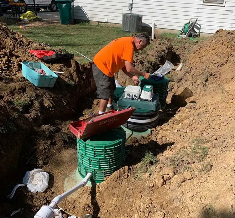 man installing a new septic tank in bloomington il