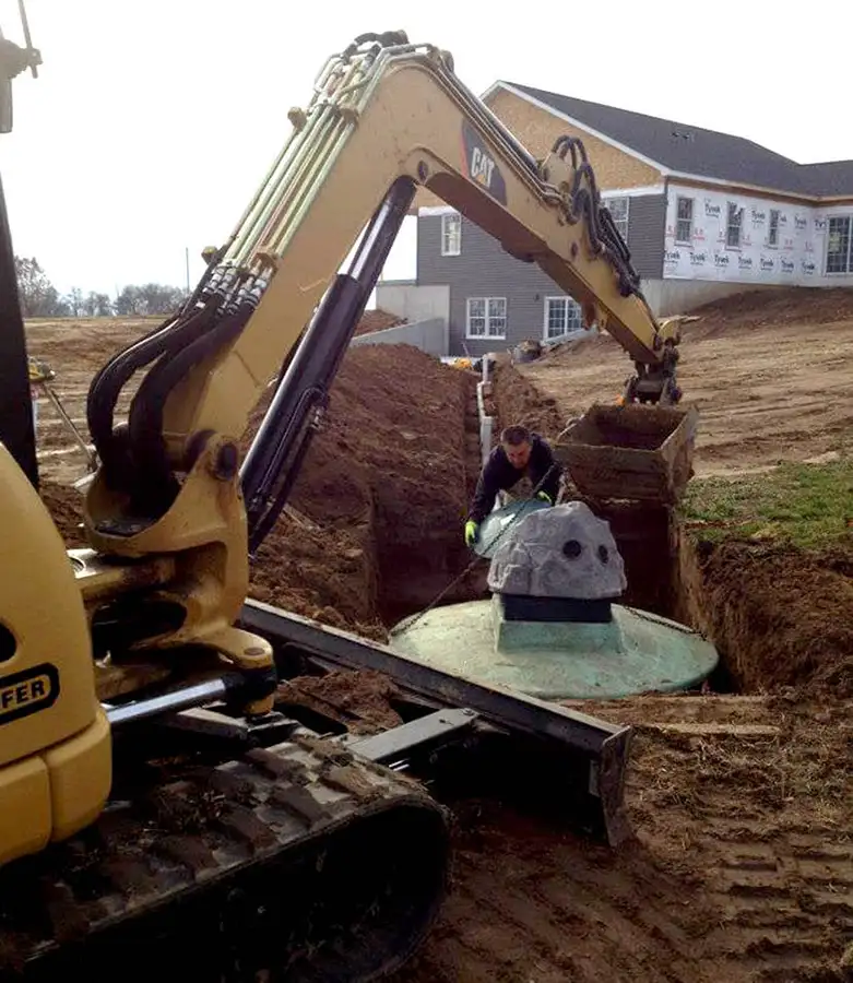 man operating heavy equipment to install a septic tank decatur il