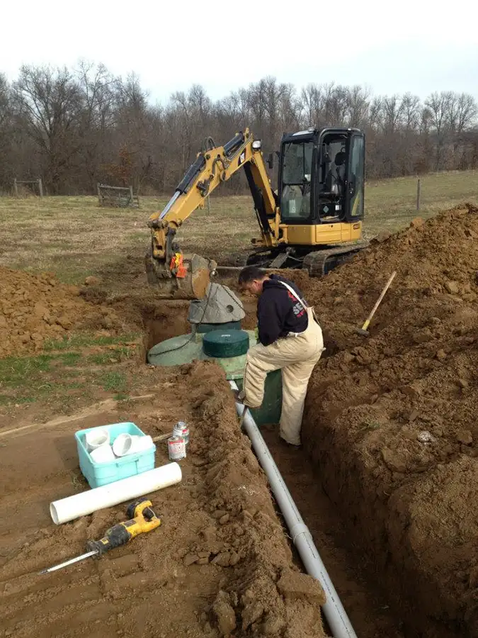 sewer & septic specialist employee installing a sceptic system decatur il
