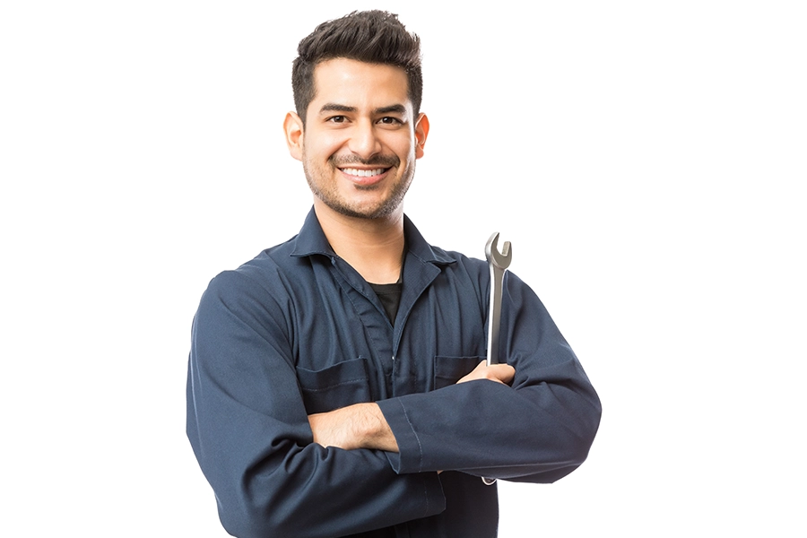 Sewer & Septic Specialist—A smiling male plumber holding a wrench, ready to address septic system problems at a residence in Decatur, IL.