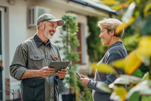 Sewer & Septic Specialist—A plumber talks with a homeowner about her septic system in Decatur, IL.